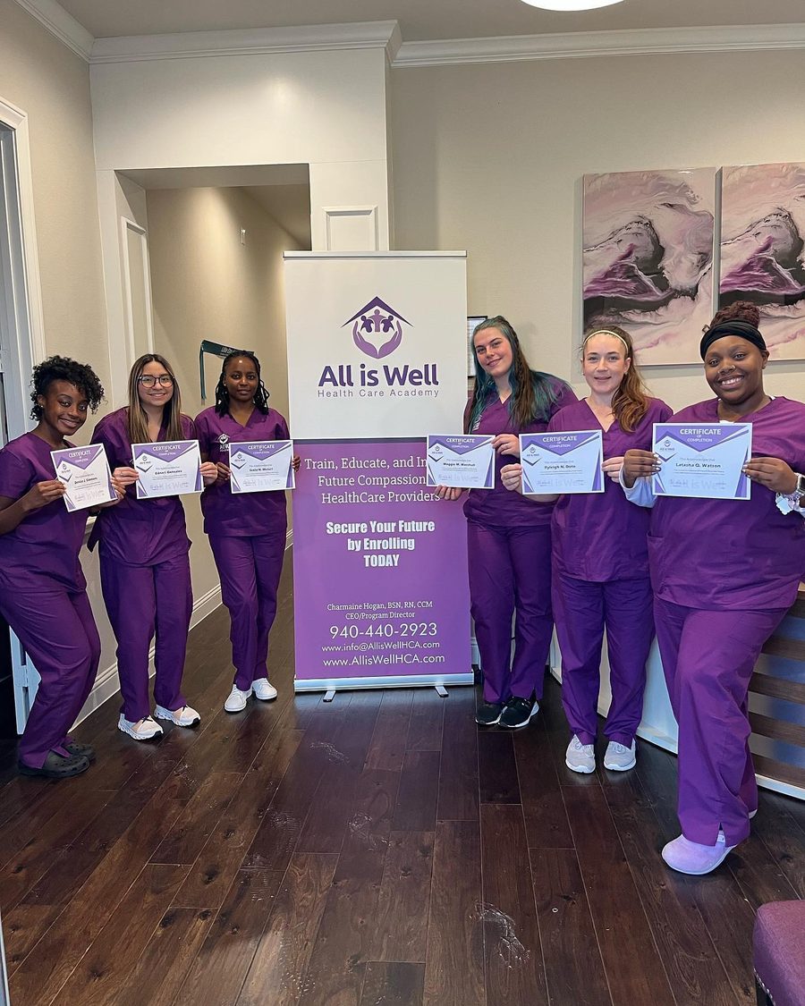 Cohort holding their certificates at All is Well